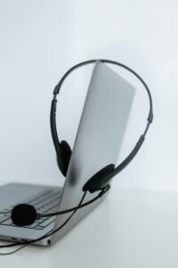 A sleek laptop with a headset, ideal for remote work or online communication.